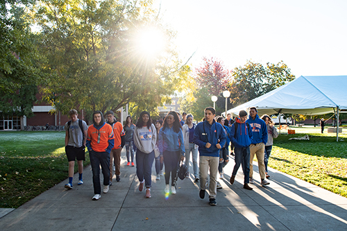 A tour guide leads students around the Boise State University campus.